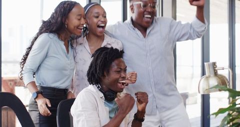 Diverse Team Celebrating Success Together in Office Environment