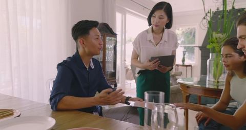 Diverse couple meeting wedding planners at home