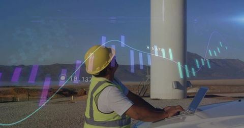 Technician Analyzing Data at Wind Turbine Site for Renewable Energy