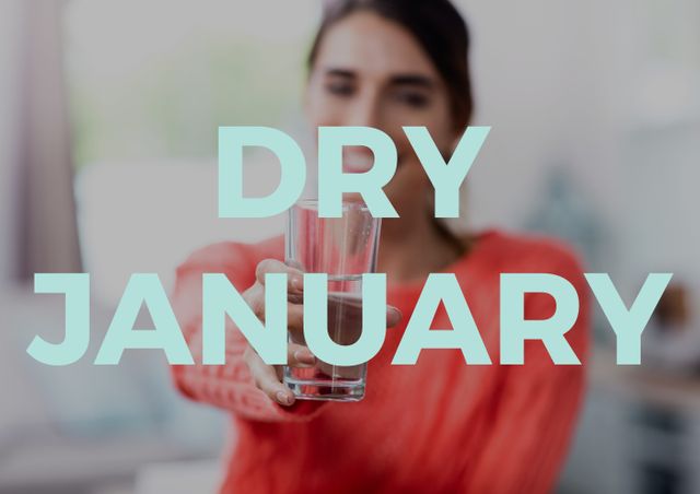 Woman promoting Dry January by holding an empty glass. This image can be used for campaigns or articles about health and wellness, sobriety, detox programs, and New Year resolutions.