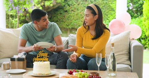 Couple Celebrating with Cake and Gifts in Cozy Setting