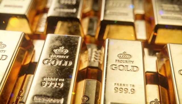 Shining stacked gold bars featuring crown emblems and 999.9 purity for investment