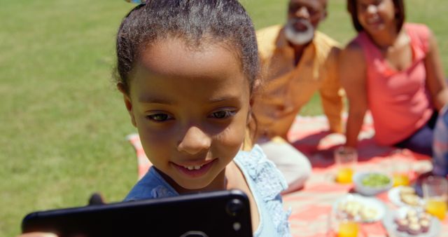 Young Girl Taking Selfie at Family Picnic in Park - Download Free Stock Images Pikwizard.com