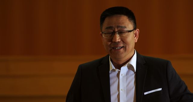 Smiling Businessman in Dark Suit Against Wooden Background - Download Free Stock Images Pikwizard.com