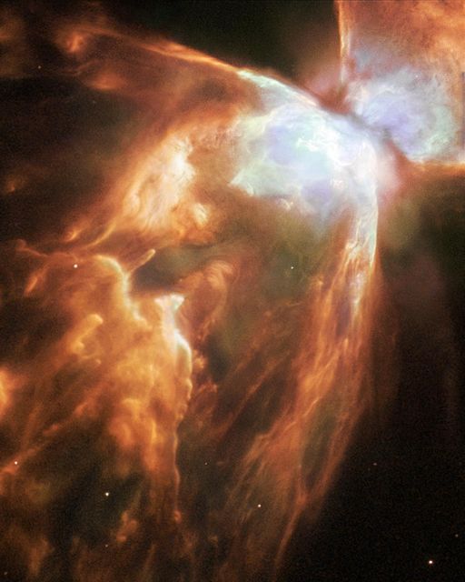 Capturing the breathtaking Bug Nebula, this image taken by NASA's Hubble Space Telescope reveals one of the brightest and most extreme planetary nebulae known. The fiery core of the nebula is enveloped by a blanket of icy hailstones, with walls of compressed gas and trailing strands. Ideal for use in educational materials, scientific discussions on astronomy, or inspirational space exploration content.