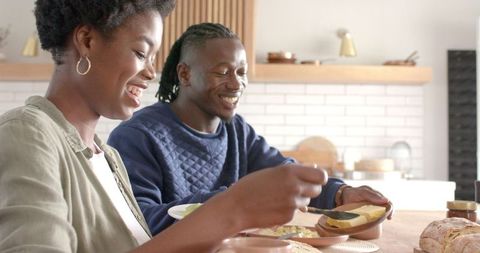 Couple Sharing a Heartfelt Breakfast in Minimalist Kitchen Space