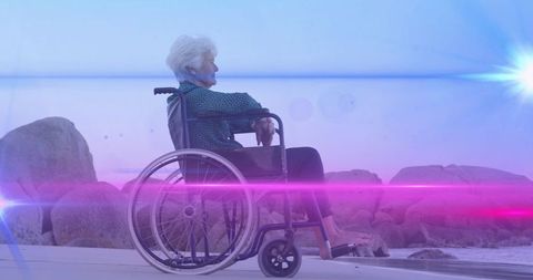 Senior Woman in Wheelchair Enjoying Serene Beach Sunset