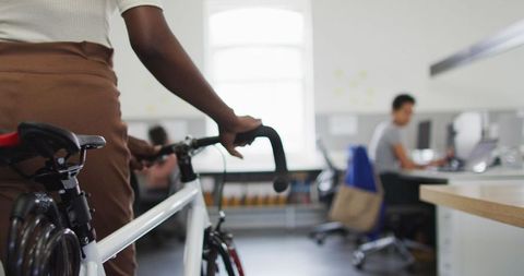 African American Businesswoman Arrives at Office with Bicycle