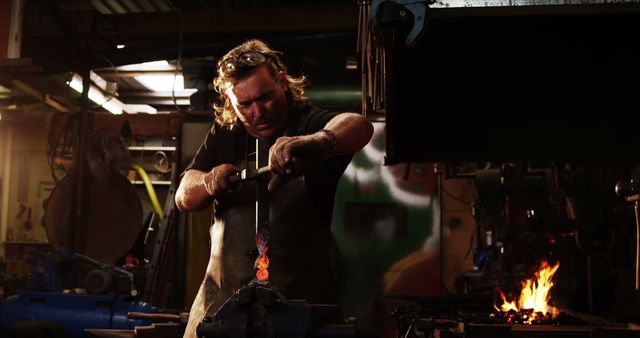 Focused Blacksmith Shaping Glowing Red Hot Metal - Download Free Stock Images Pikwizard.com