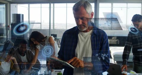 Businessman Using Tablet with Holographic Interfaces in Office