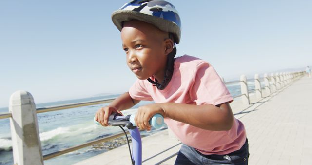 Young Boy Riding Scooter Near Beach on Sunny Day - Download Free Stock Images Pikwizard.com