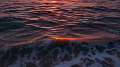 Calm Sunset with Vibrant Ocean Waves and Golden Reflection