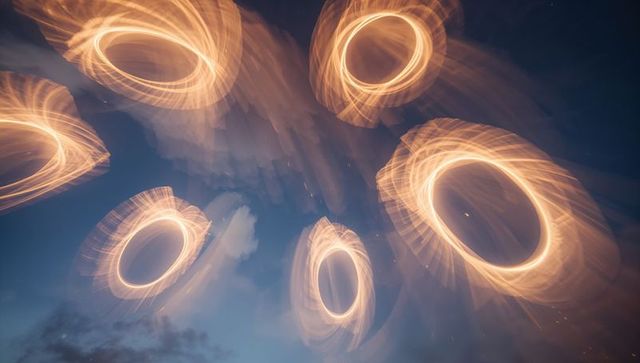 Glowing rings spiraling across twilight sky with motion blur and amber sparks