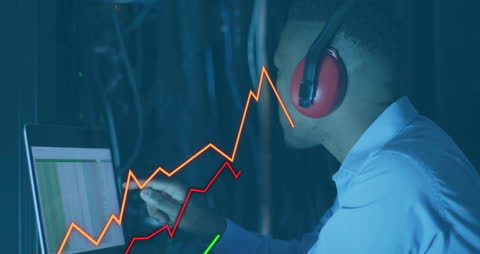 Businessman Analyzing Financial Data on Laptop in Server Room