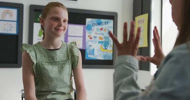 Teacher Using Sign Language with Student in Classroom - Download Free Stock Images Pikwizard.com