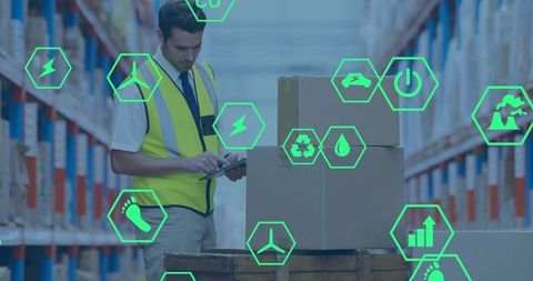 Warehouse worker scanning inventory with tablet and neon sustainability data icons overlay