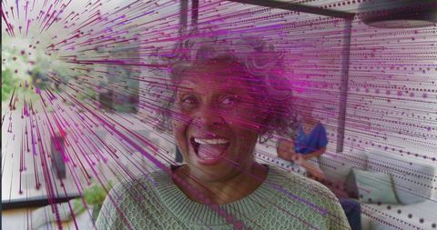 Smiling senior woman laughing on covered patio with magenta glitch overlay joyful portrait