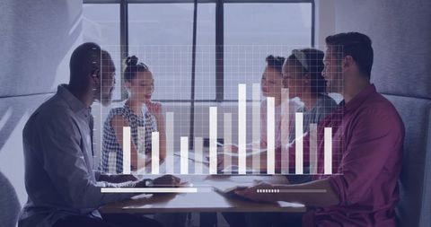 Diverse Team Discussing Business Planning with Analytics in Modern Office