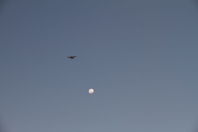 Daytime Aircraft Flying Over Moon in Clear Sky - Download Free Stock Photos Pikwizard.com