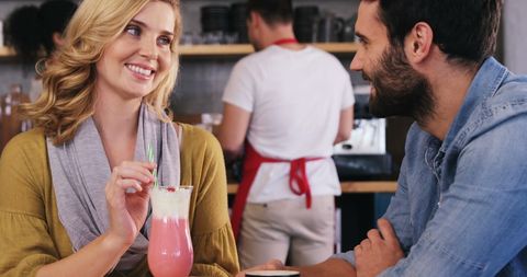 Smiling Couple Enjoying Beverages in Cozy Cafe - Download Free Stock Images Pikwizard.com
