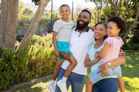 Happy family enjoying quality time in sunny backyard