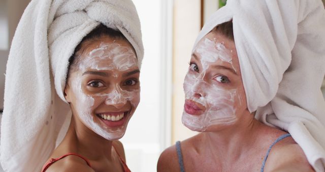Diverse happy female friends wearing towels on heads and cleansing masks taking selfie at home - Download Free Stock Photos Pikwizard.com
