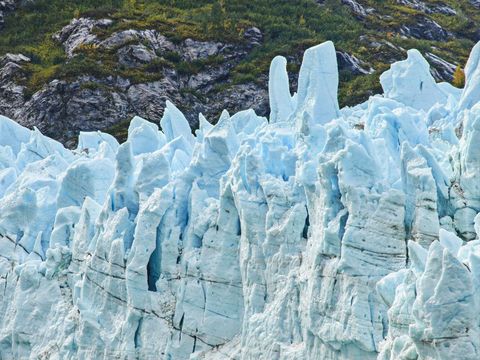 Jagged Glacier Ice Spires Rising Against Rugged Tundra Hills