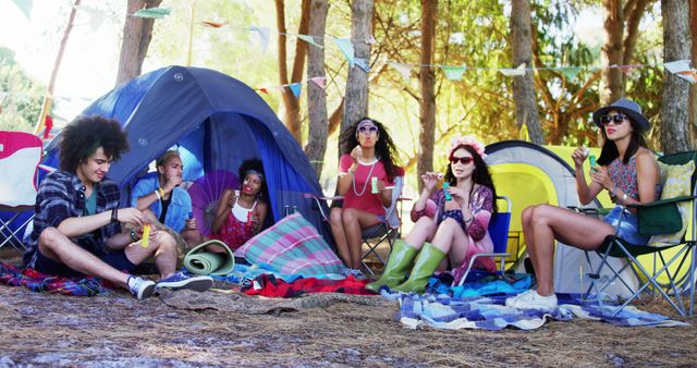 Young friends camping in forest, enjoying bubble blowing, outdoors adventure - Download Free Stock Images Pikwizard.com