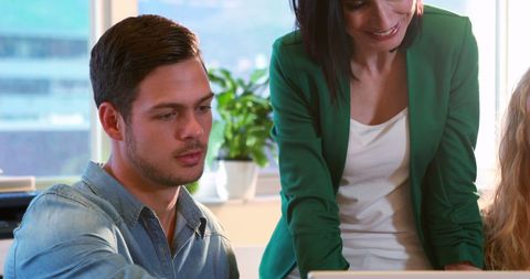 Collaboration in Modern Office Setting with Laptop