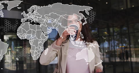 Transparent World Map Overlaying Businesswoman Using Smartphone