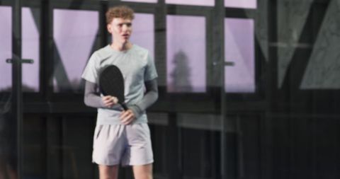 Male Athlete Preparing for Padel Match Indoors