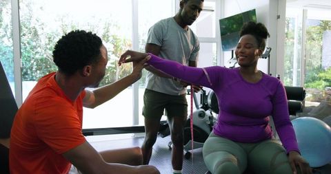 Friends Enjoy Exercising Together in Cozy Home Gym Environment