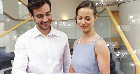 Business Colleagues Analyzing Data with Social Media Icons Overlay