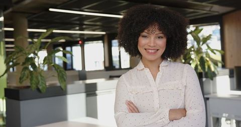 Confident Professional Woman Smiling in Modern Office Workspace