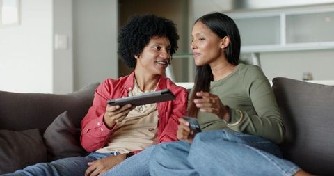 Couple Relaxing at Home Interacting with Technology
