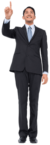 Smiling asian businessman pointing upward transparent background