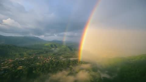 Soaring Over Tropical Valley Showcasing Vivid Double Rainbow