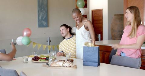 Friends sharing warm hug at home celebration gathering