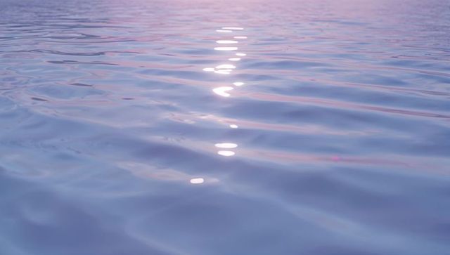 Serene Dawn Water with Pastel Ripples at Sunrise