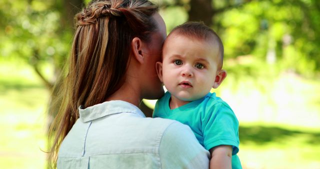 Mother Holding Infant in Park on Sunny Day - Download Free Stock Images Pikwizard.com