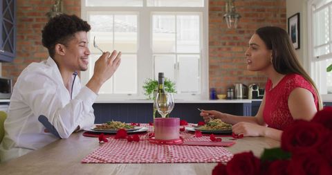 Young Interracial Couple Enjoying Romantic Dinner at Home