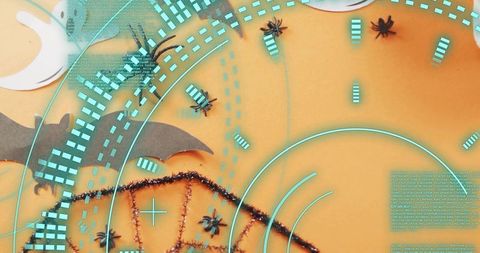 Pulsing cyan radar overlay over halloween flatlay with spiders bat silhouette tinsel