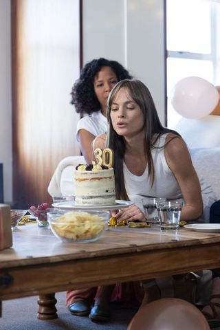 Women Celebrating 30th Birthday with Friends and Cake