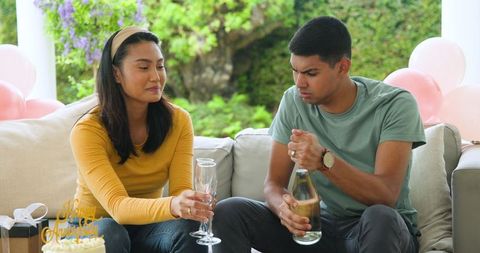 Young couple celebrating anniversary with champagne
