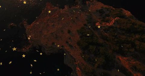 Celestial Stars Hovering Over Rocky Coastal Cliff at Night