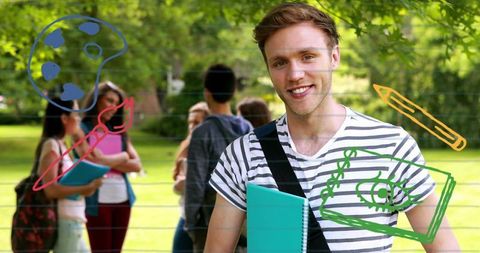 Smiling male student holding teal notebook wearing striped tee with doodle overlay