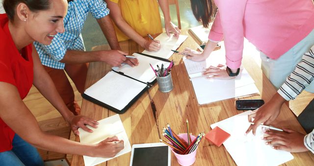 Creative Team Collaborating on Project at Work Table - Download Free Stock Images Pikwizard.com