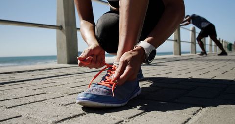 Runner Tying Laces on Seaside Promenade for Safe Jog - Download Free Stock Images Pikwizard.com