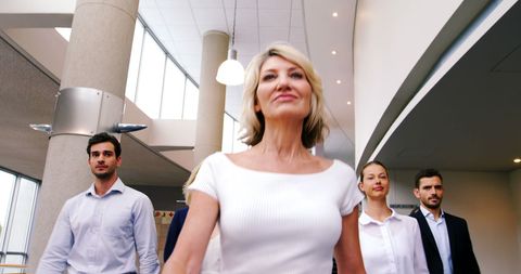 Confident Female Leader Guiding Young Professionals in Office Lobby - Download Free Stock Images Pikwizard.com