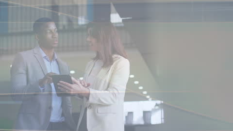 Young Professionals Discussing Ideas on Tablet in Modern Office